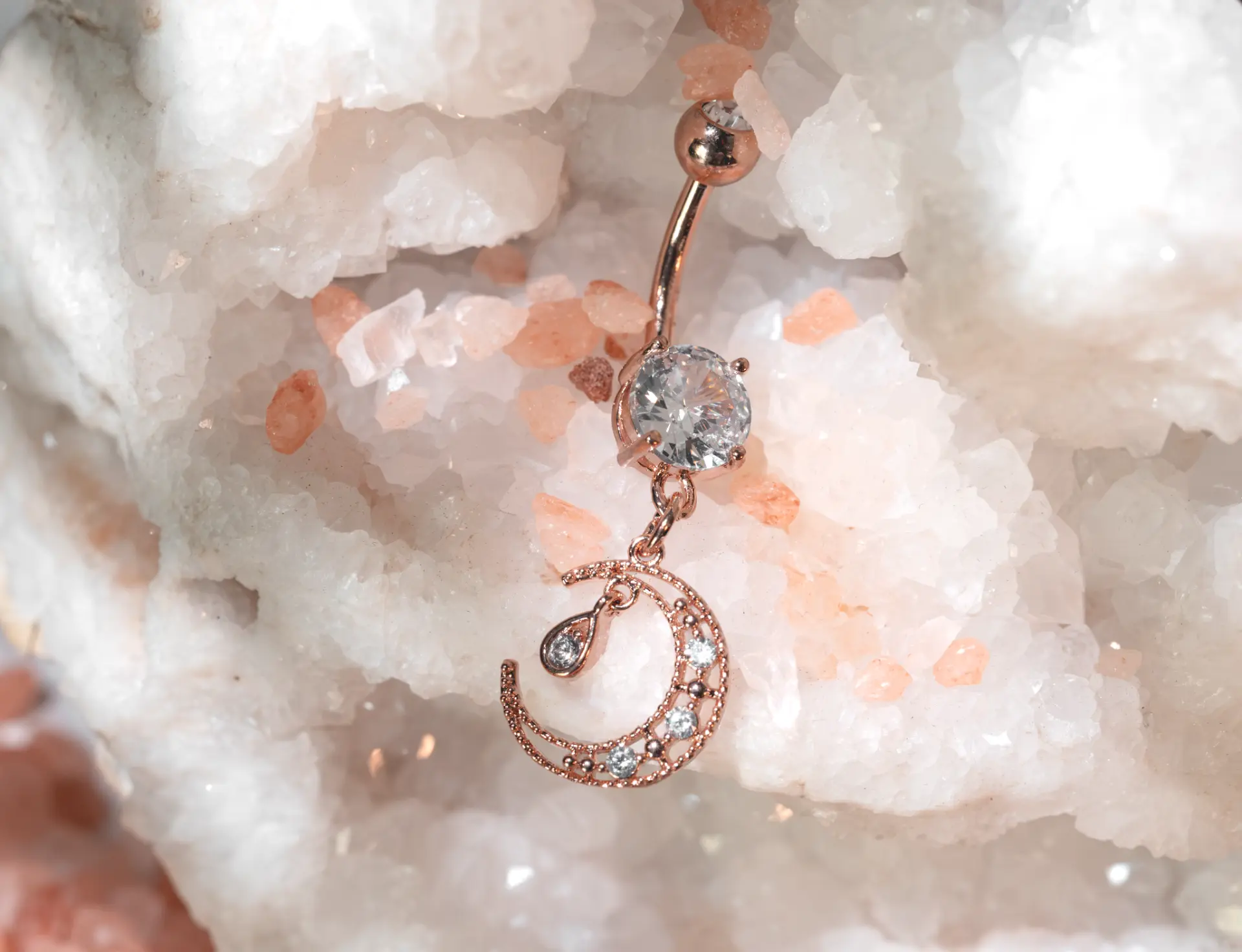 Rose gold crescent moon belly ring with crystal accents, body jewelry available in store at Nex Generation Jewelry in St. Peters, MO